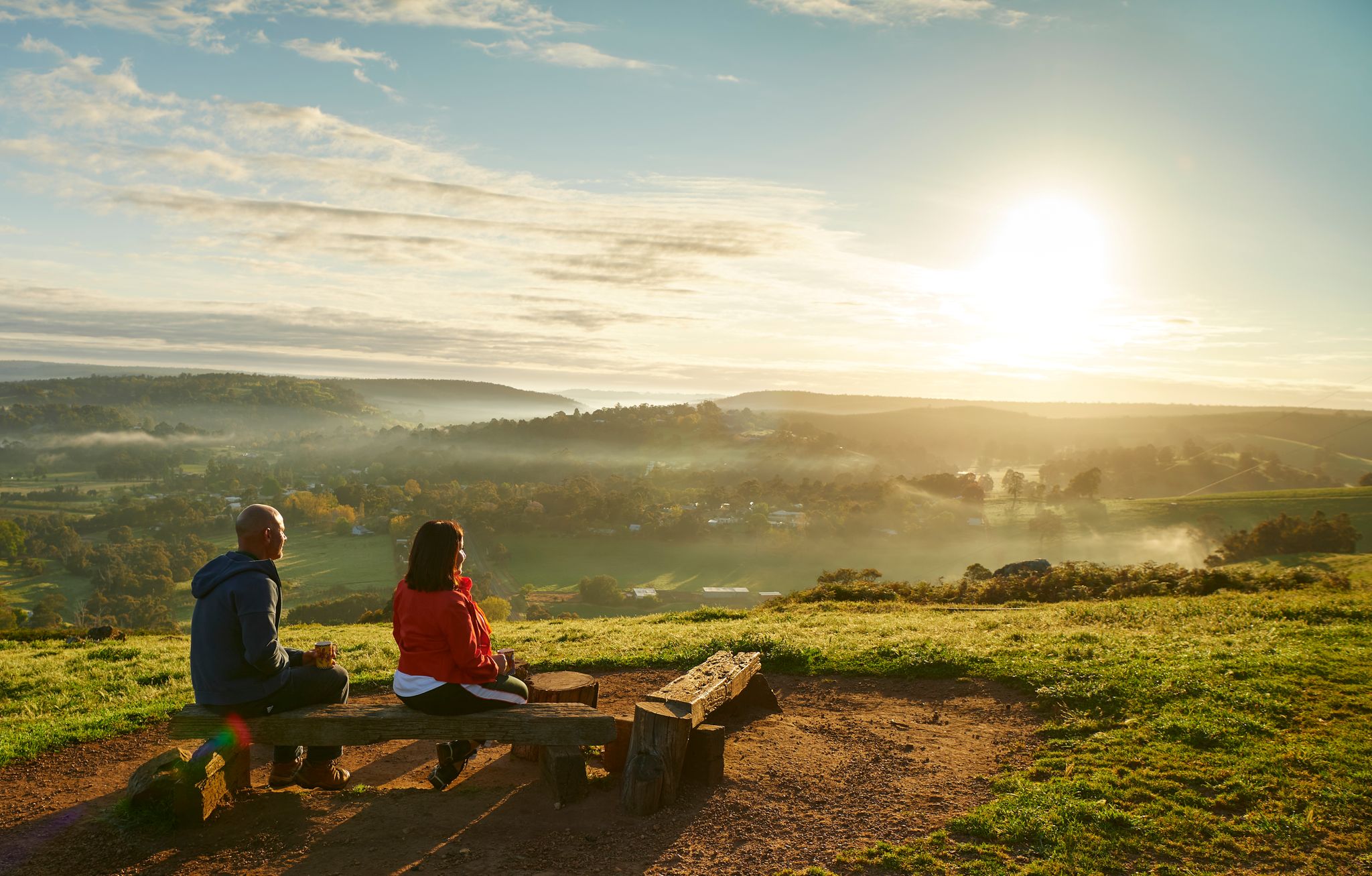 A couple take in the panoramic sunset over Balingup, Western Australia.