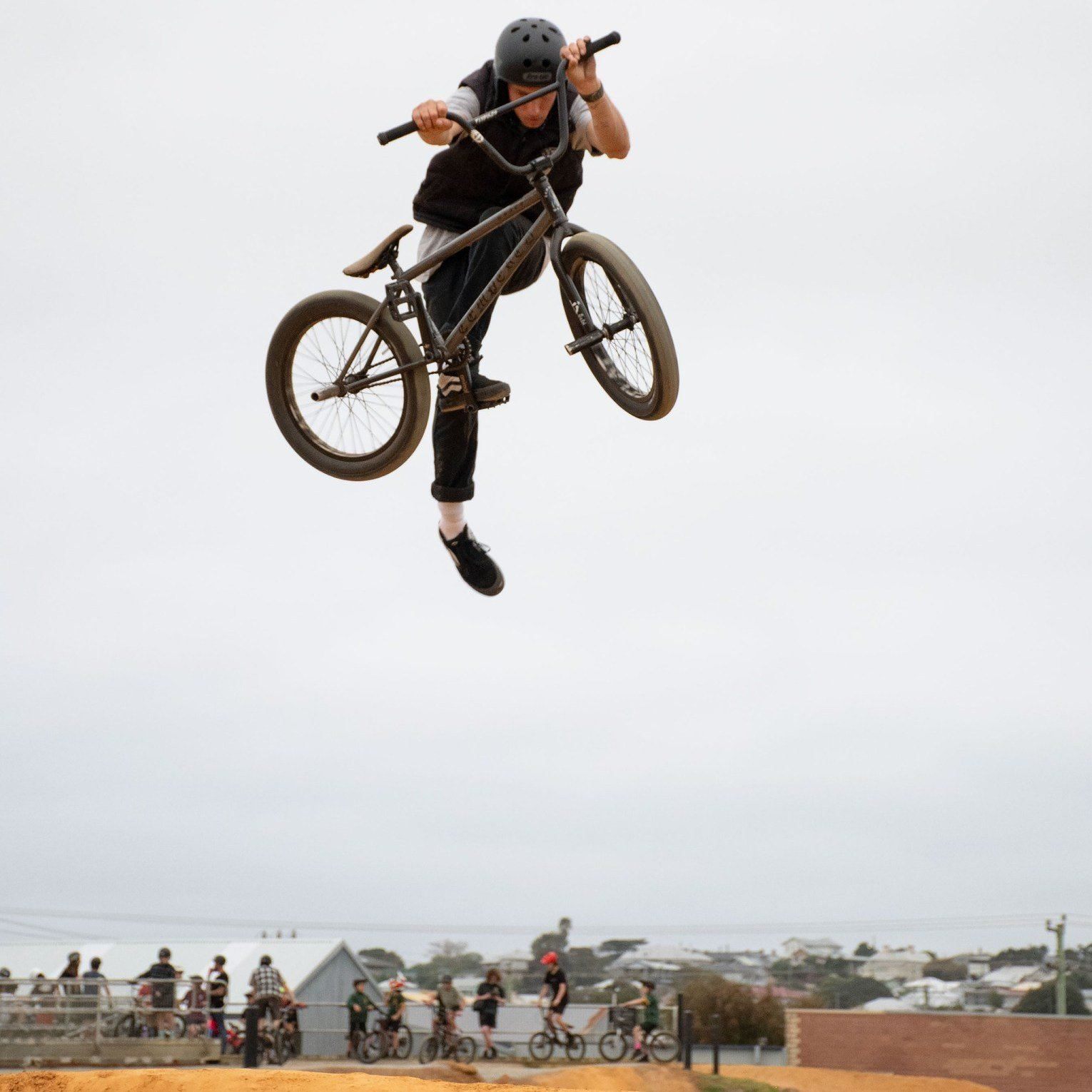 A person mid-air doing a trick on a bike