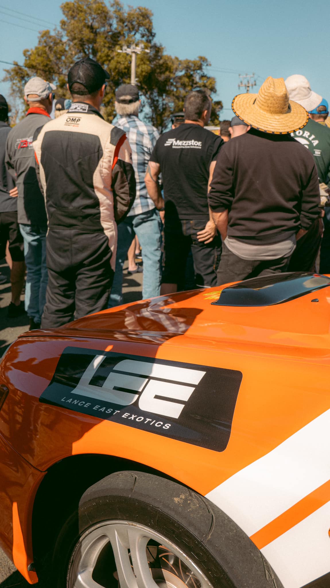 Car with people standing infront